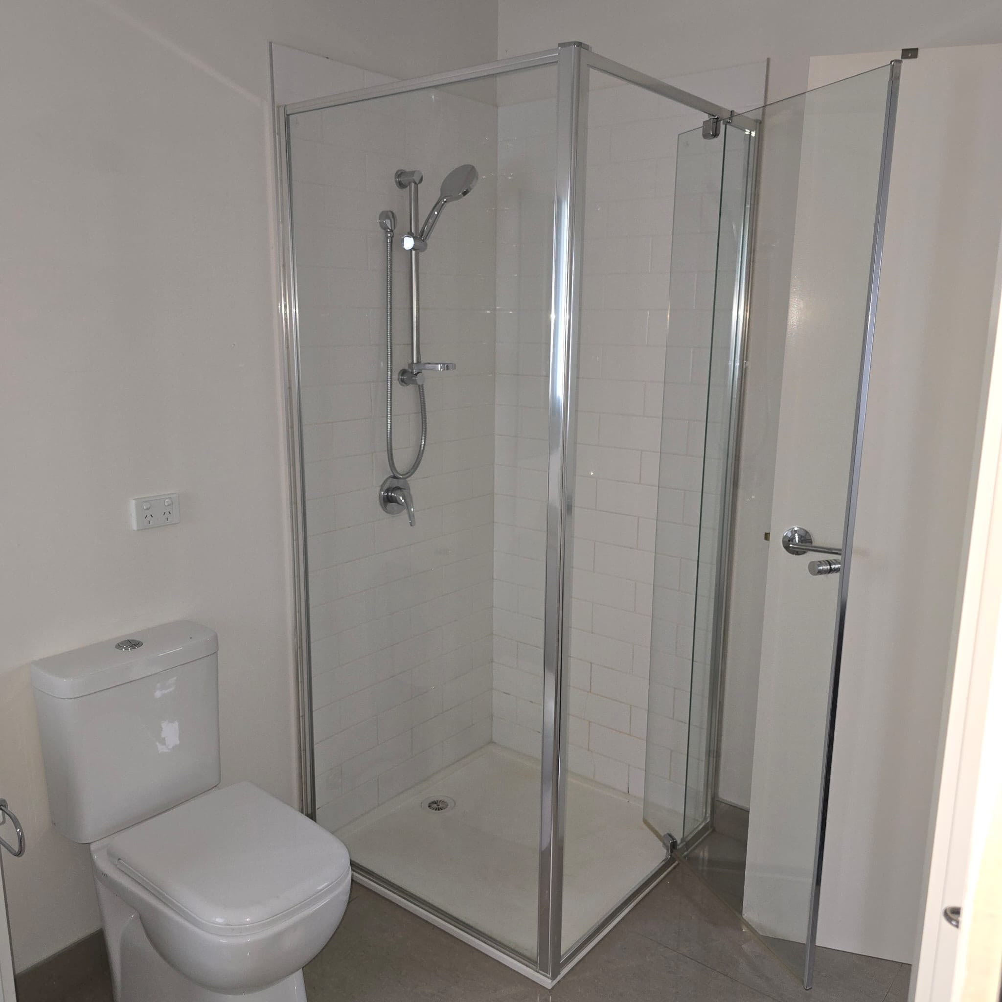 Melbourne bathroom after renovation, with a fully tiled shower, glass screen and new tapware