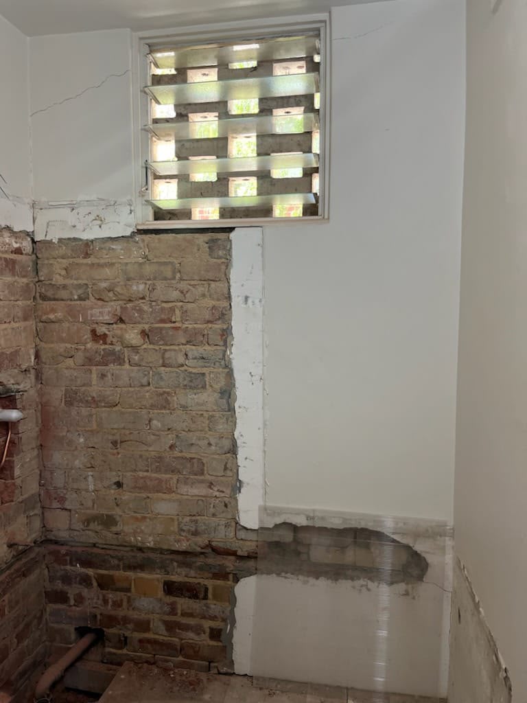 Wet area stripped back to brick and render before waterproofing