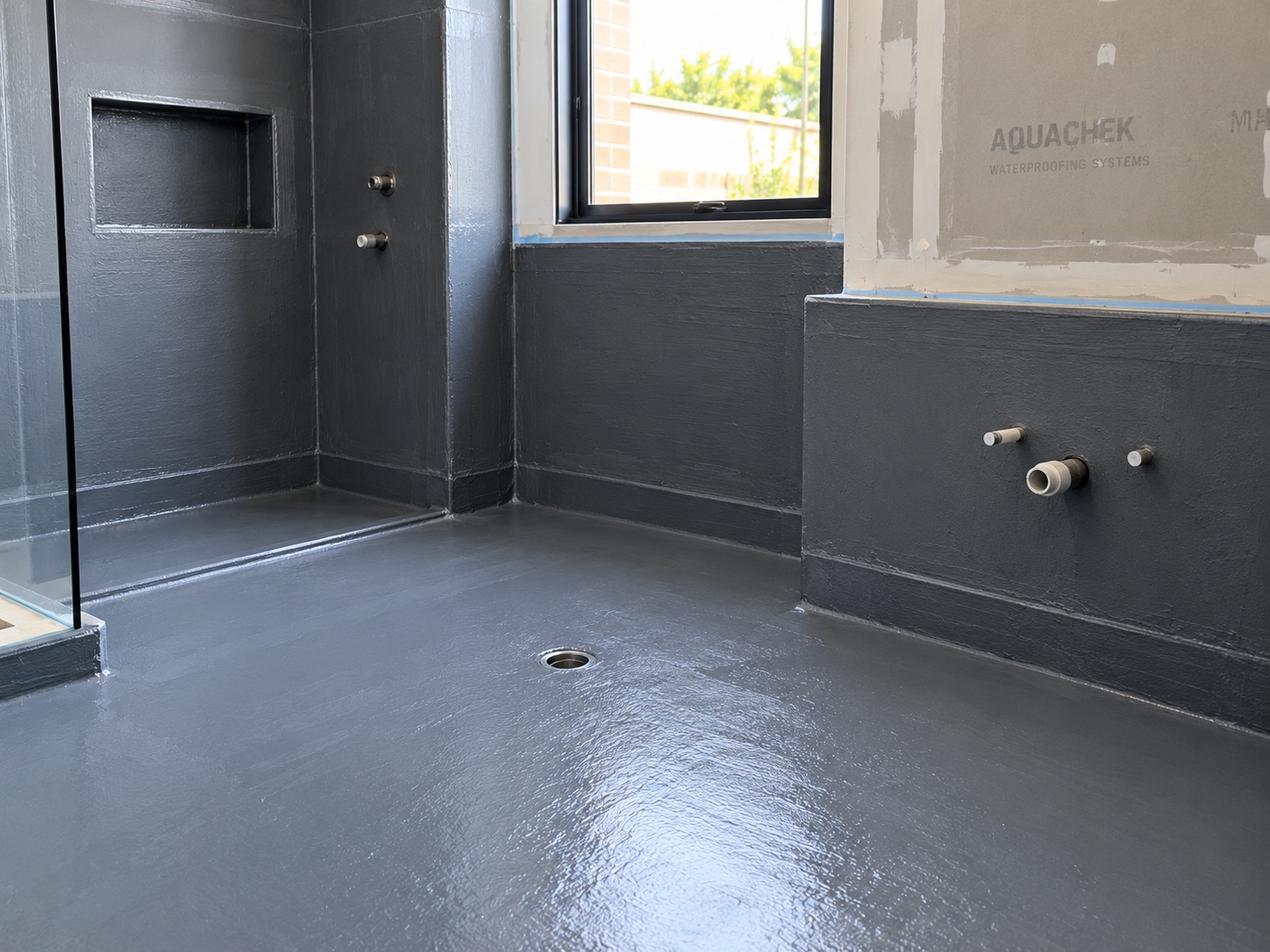 Bathroom waterproofing membrane applied to floor, shower and walls before tiling